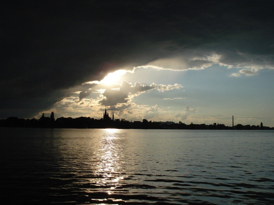 havel river under dark clouds at sunset, germany, werder