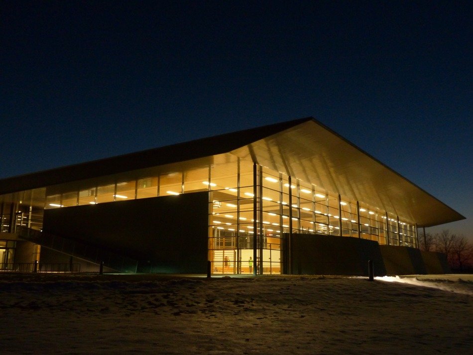 illuminated glass building of gym center at night