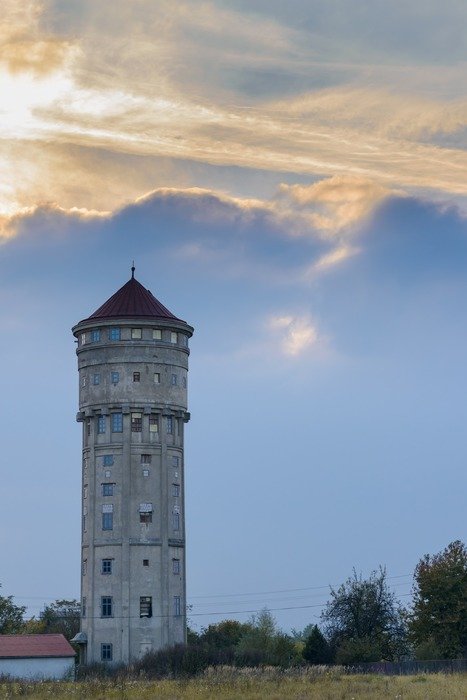 old water tower in countryside at evening