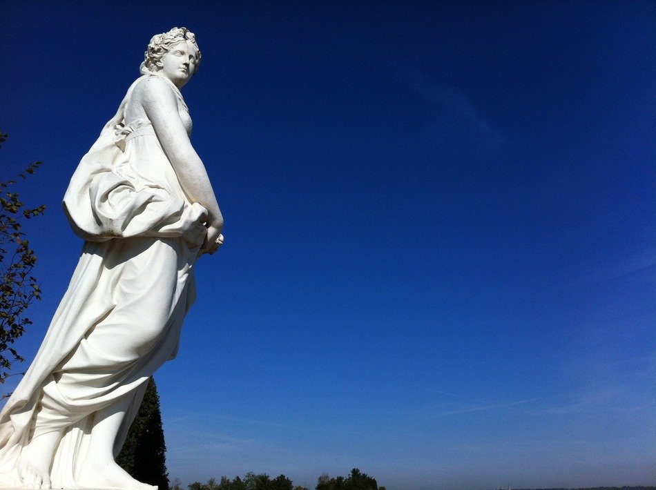 beautiful woman, classic sculpture at sky, france, versailles