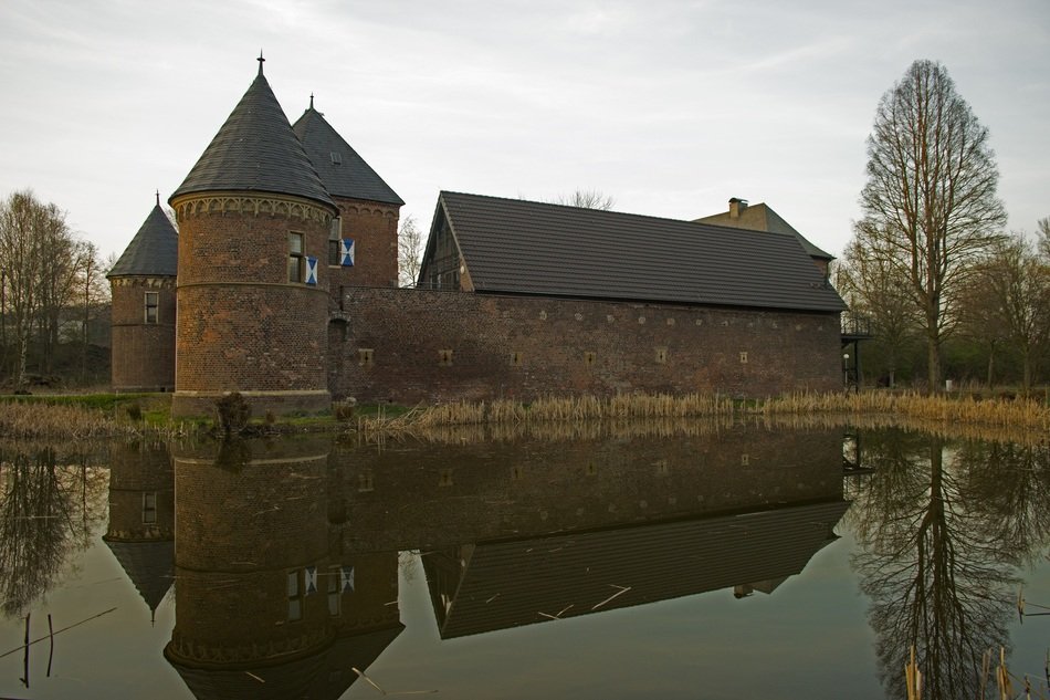 Water mirroring ancient castle architecture