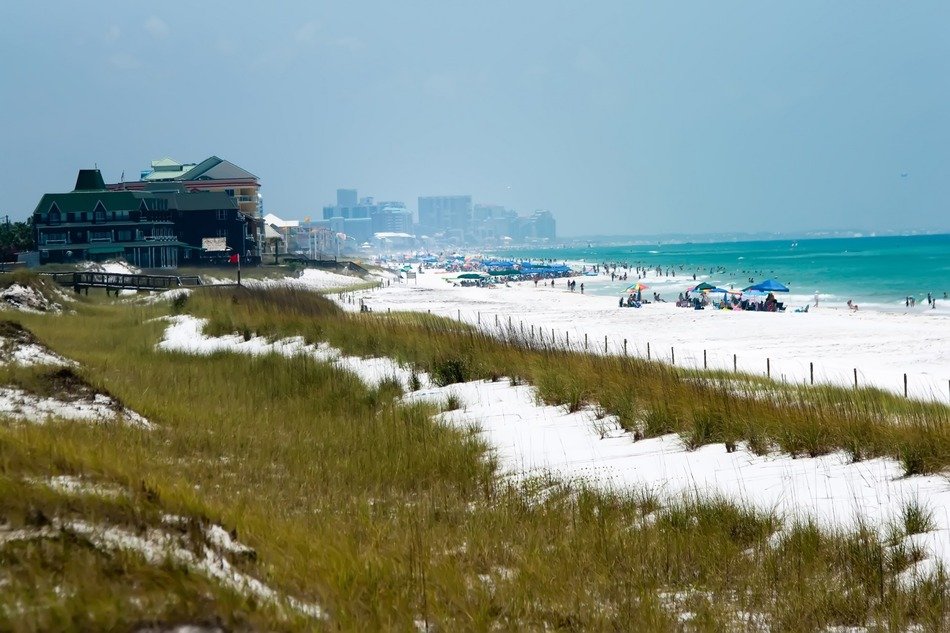 people on sand beach at distant city, usa, florida, gulf mexico