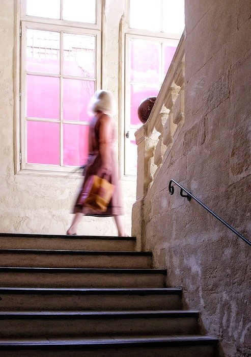 People walking up the stone stairs