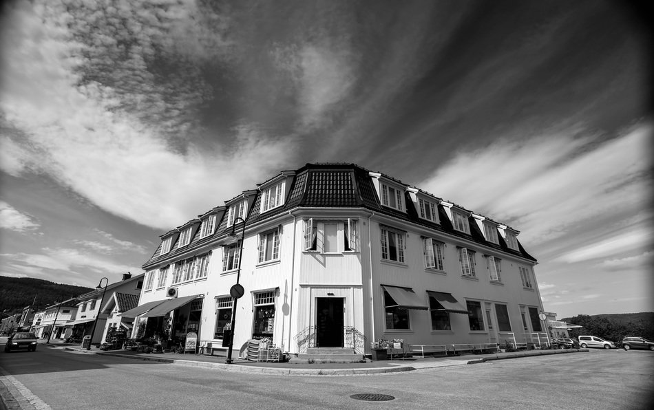 Black and white picture of white corner house