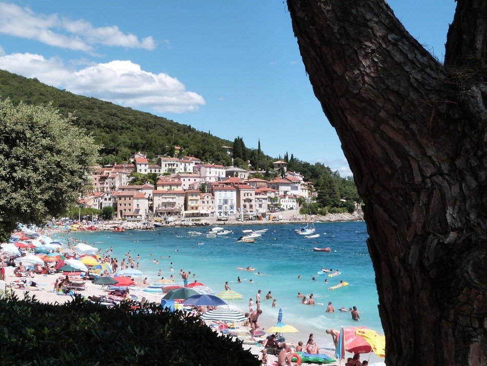 people on sea beach at old town on hill