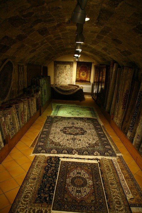 ornamental carpets in dark shop on floor