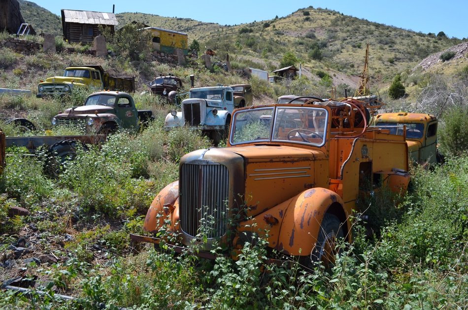 rusty old trucks on hill side at ghost town, usa, arizona, jerome