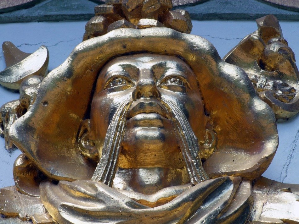 golden head of chinese man, ornament on tea house