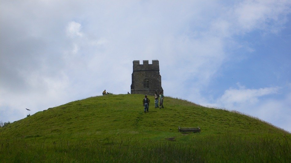 people on the background the Glastonbury tower