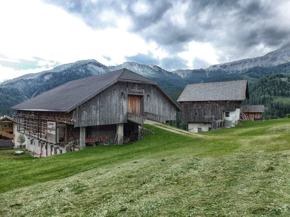 huts at mountains under clouds, scenic landscape, italy