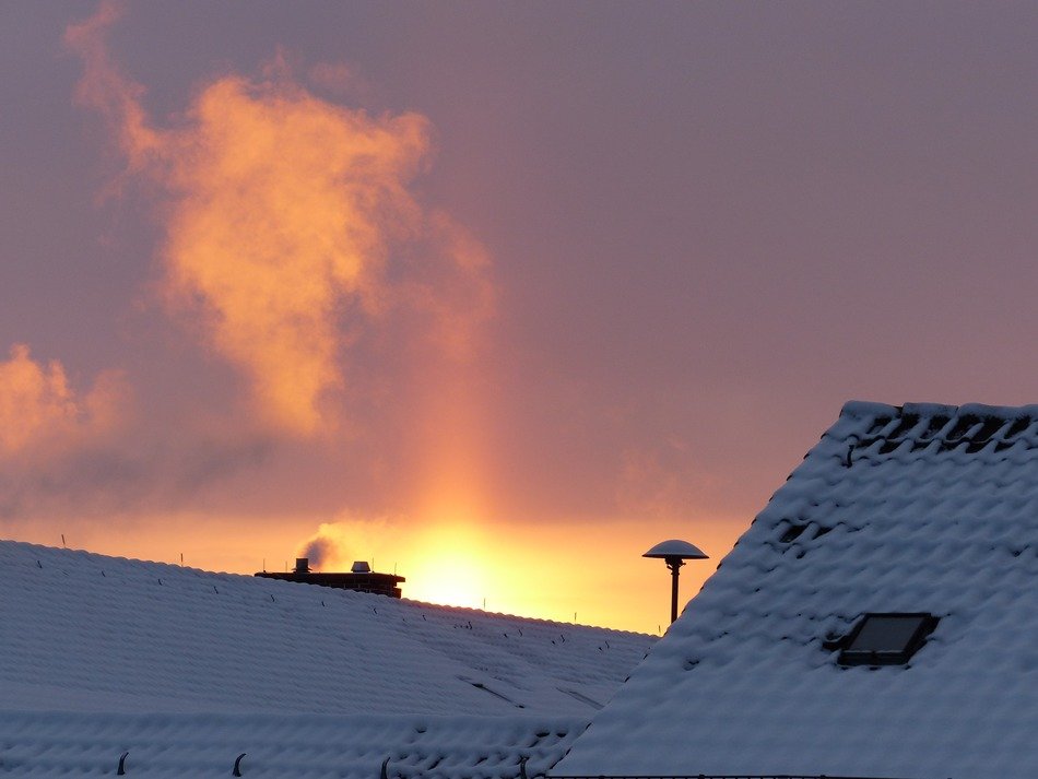 chimney smoke at winter sunrise
