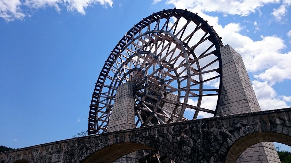 aged wooden waterwheel at sky, japan, yamaoka