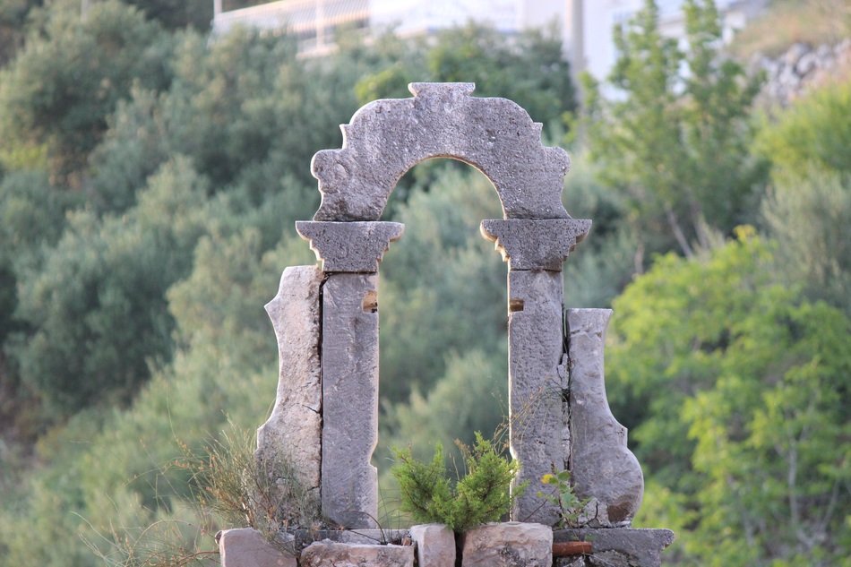 aged stone arch, monument on cemetery, croatia