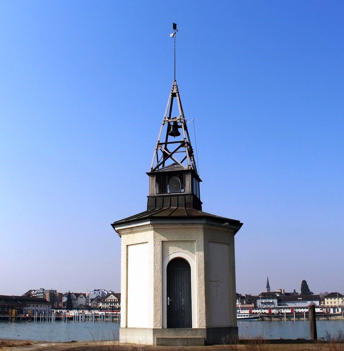 bell tower at water in view of old town