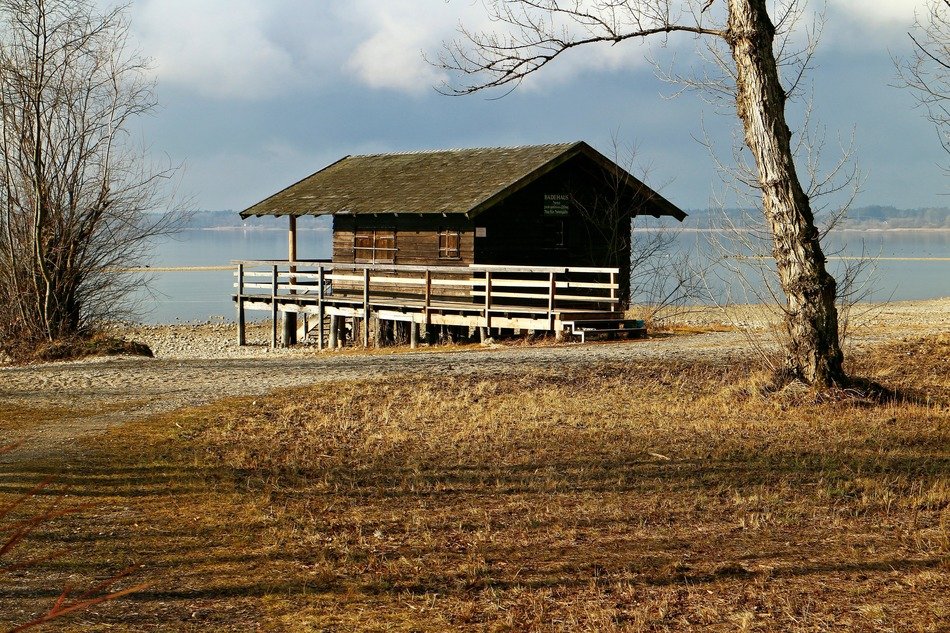 weathered wooden hut on beach at fall