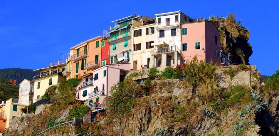 colorful old houses on rock under blue sky, italy, cinque terre