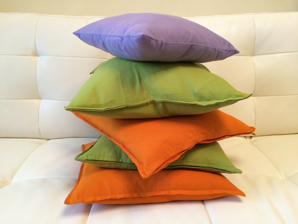 stack of colorful pillows on sofa