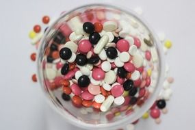 colored pills in a glass