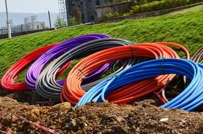 colorful pipes in coils on ground