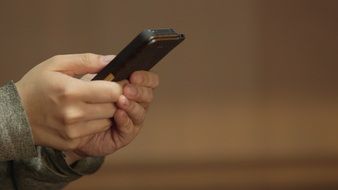 black device in hand