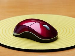 red computer mouse on the mat