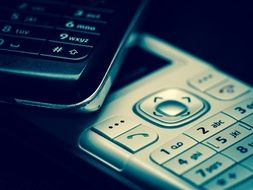 Two mobile phones on a black background