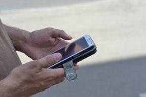 man holds a smartphone in his hands