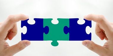 puzzle pieces in human hands