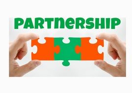 The word "partnership" above puzzles in hands