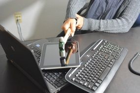 person smashing devices with hammer