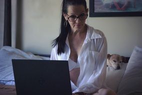 Portrait of sitting woman looks at computer