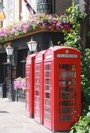 three vintage telephone booth on street, uk, england, london