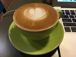 green cup of coffee on a plate
