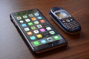 smartphone and push-button telephone on the table