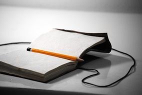 yellow pencil on notebook