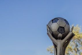 sculpture of the Football Cup against the sky