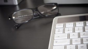 keyboard and glasses in the workplace