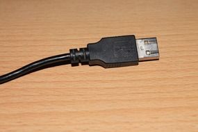 usb plug on wooden surface