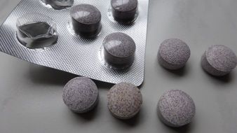 Large round tablets in a blister and near