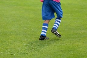 boy playing football on the field