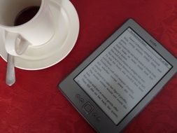 kindle e-book and cup of coffee