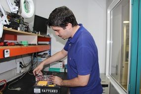 man unpacking hardware in workshop