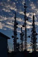 silhouettes of antennas in the sky