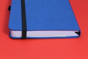 blue notebook on a red table