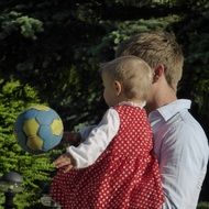 dad with a child are playing ball