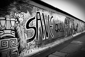 black and white picture of graffiti on the wall in Berlin