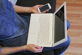 white laptop and mobile phone