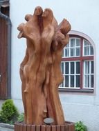 sculpture of wood near the building