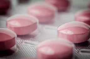 Pink round tablets in a blister