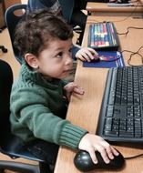 little boy with keyboard and mouse